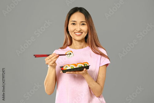 Asian woman eating tasty su...