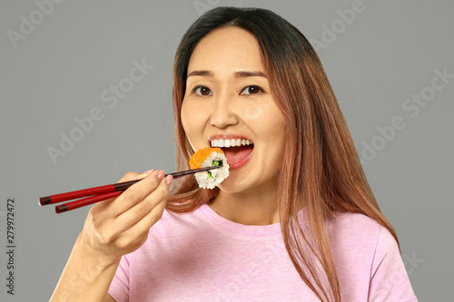 Asian woman eating tasty su...