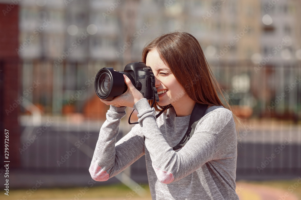 Beautiful female photographer working outdoors