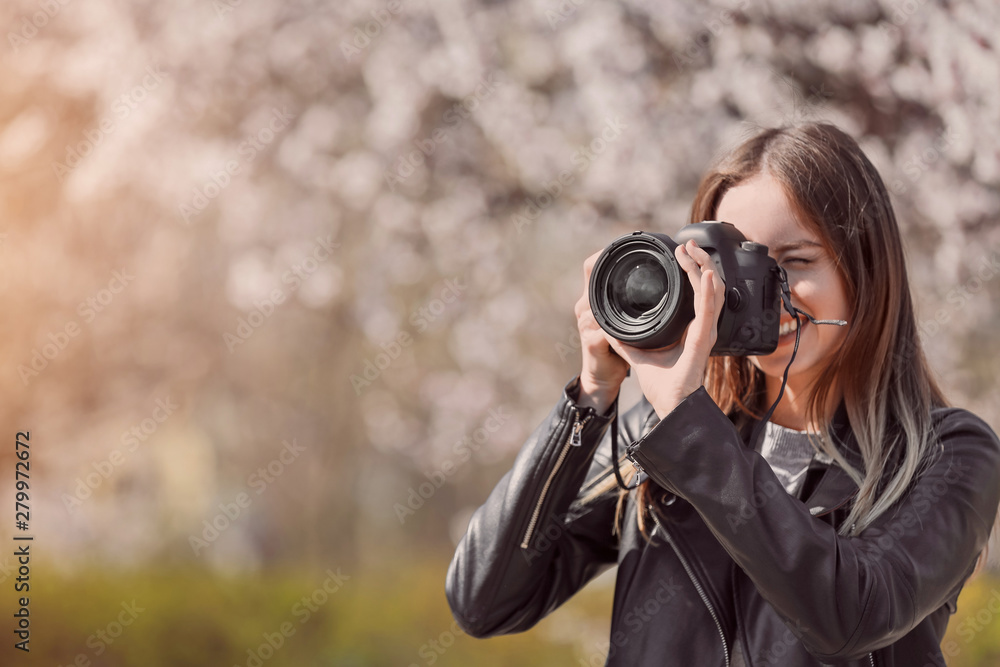 Beautiful female photographer working outdoors Beautiful female photographer working outdoors
