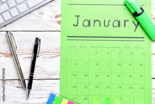 Paper calendar and pens on ...