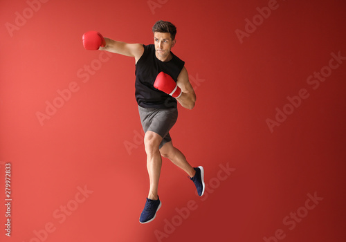 Sporty male boxer on color background © Pixel-Shot