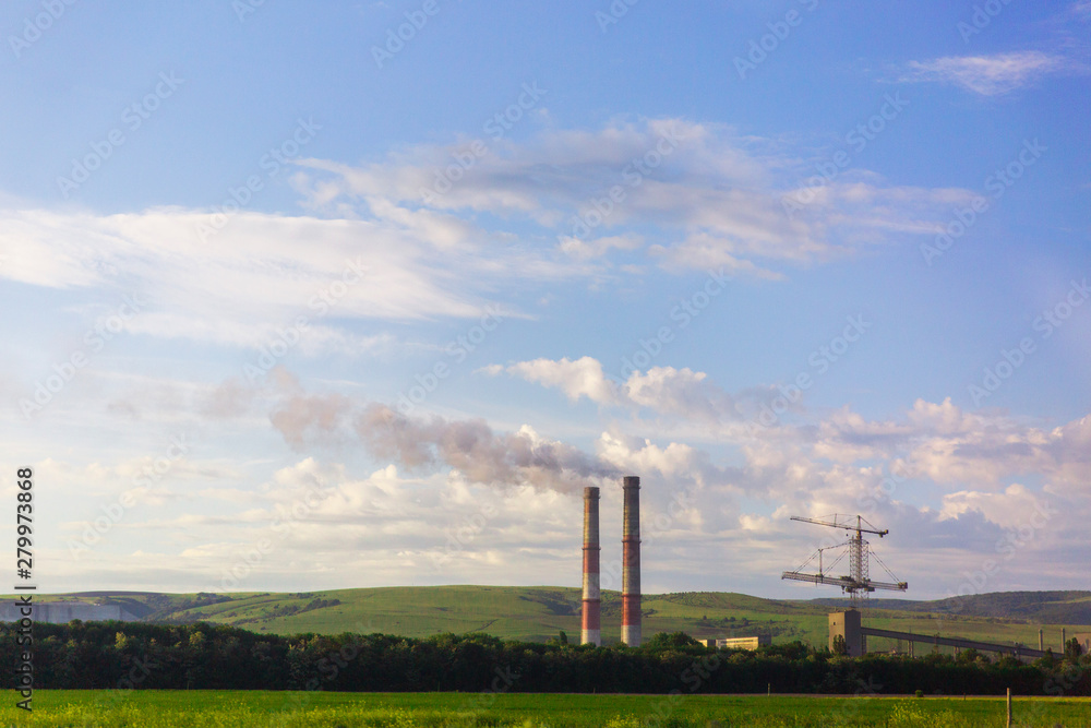 industrial pipes with smoke in the nature. Pollution of the environment. Ecological problems.