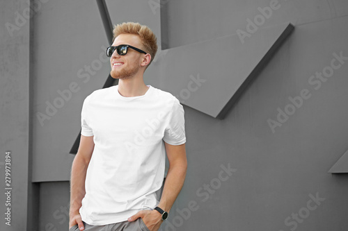 Man in stylish t-shirt near...