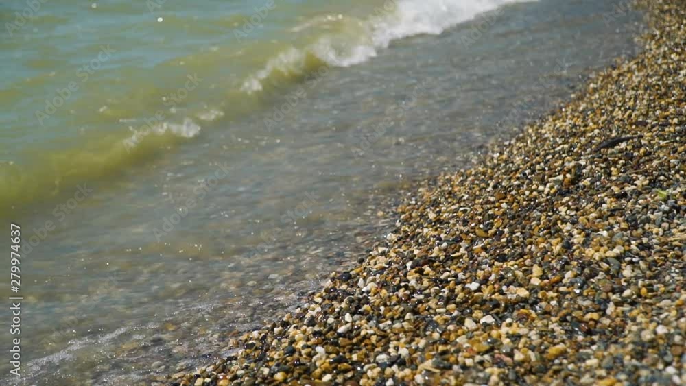 Sea Waves and the Stone Beach in Summer Day in Slow Motion. Holidays and Vacation Concept Sea Waves and the Stone Beach in Summer Day in Slow Motion. Holidays and Vacation Concept