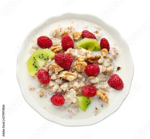 Bowl with tasty sweet oatmeal on white background