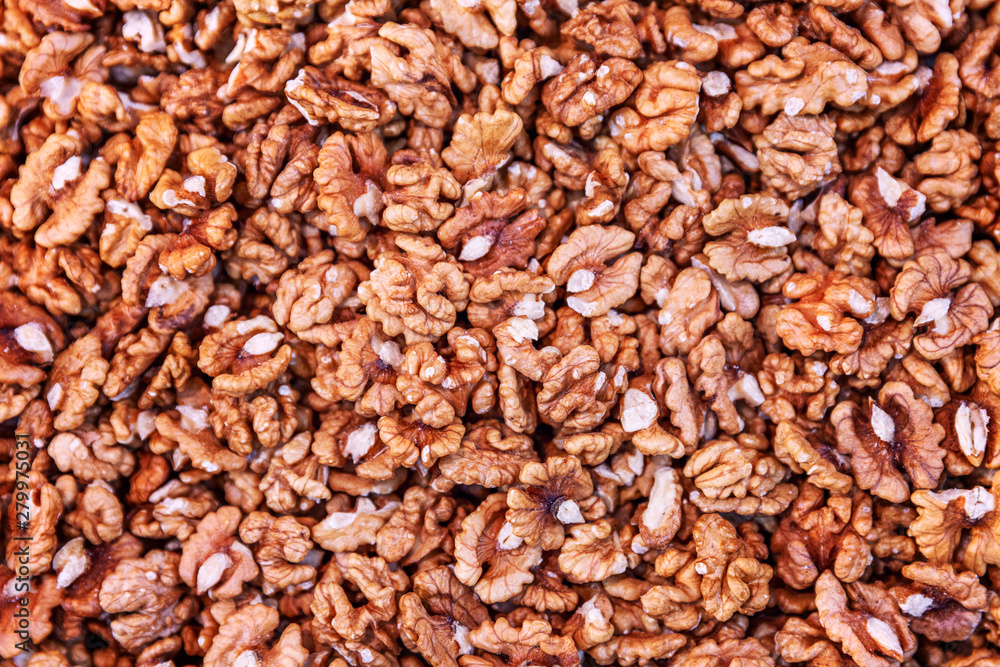 A large number of peeled walnuts. Background. Close-up. A large number of peeled walnuts. Background. Close-up.