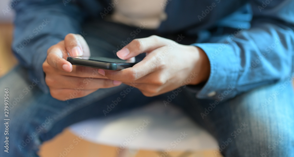 Young businessman hand's typing on his smartphone Young businessman hand's typing on his smartphone