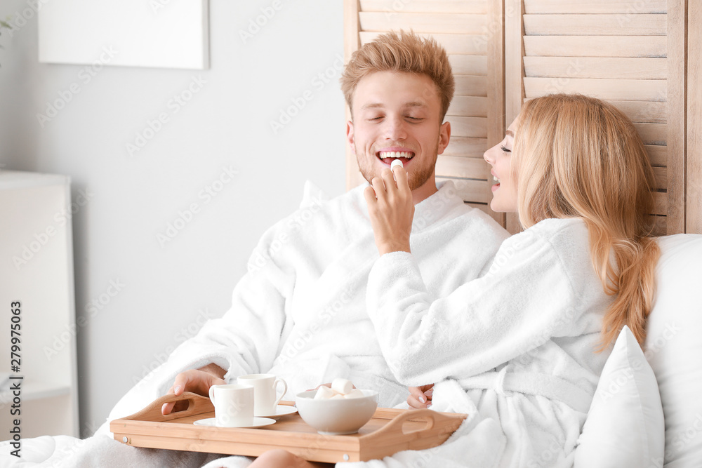 Morning of happy young couple having breakfast in bed Morning of happy young couple having breakfast in bed