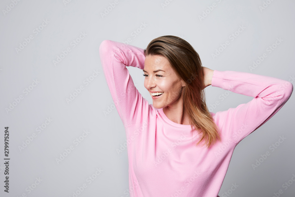 Smiling woman in pink top, looking away Smiling woman in pink top, looking away