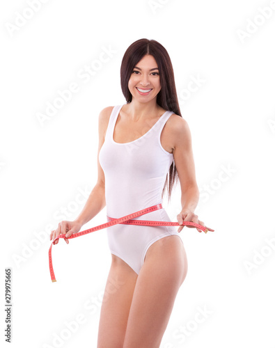 Happy pretty tanned woman with measure tape isolated on white background. Close up of sporty and beautiful female body. Healthy lifestyle, dieting, fitness, weight loss concept