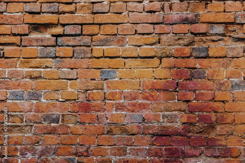 Beautiful horizontal texture of part of a old crashed brick gray wall is on the photo