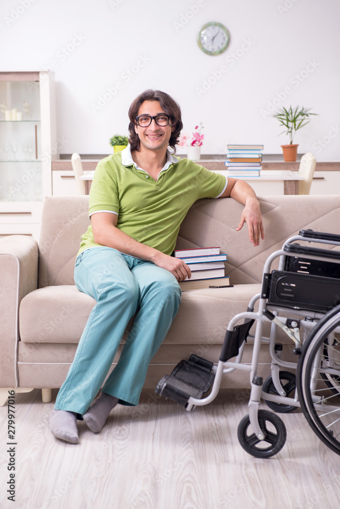 Young male student in wheelchair at home Young male student in wheelchair at home