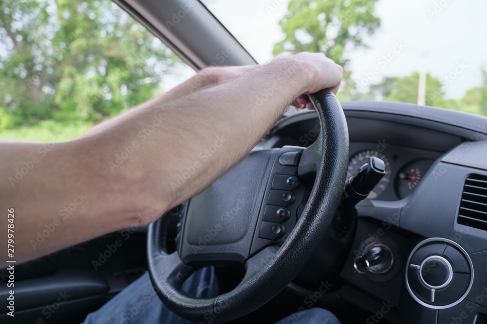 Drivers men hands on steering wheel