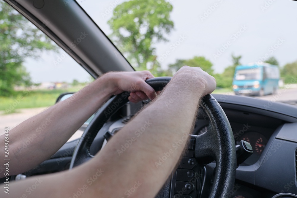 Drivers men hands on steering wheel