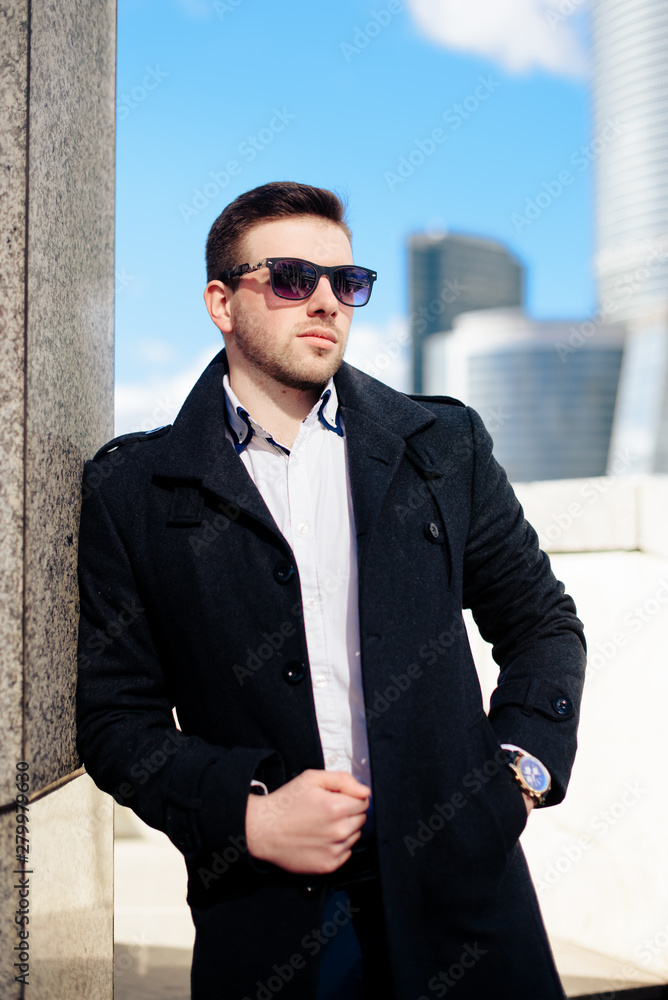 stylish young male businessman on the background of the cityscape stylish young male businessman on the background of the cityscape