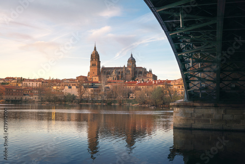 Salamanca Skyline view with Cathedral and Enrique Estevan Bridge from Tormes River at sunset - Salamanca, Castile and Leon, Spain