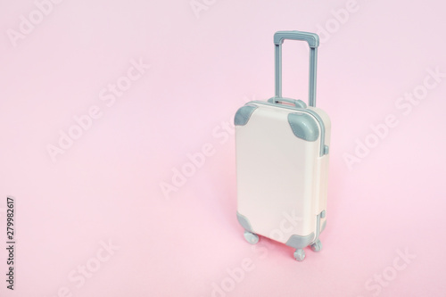 Stylish suitcase on pink background, top view with place for text. Concept for travel with place for your text