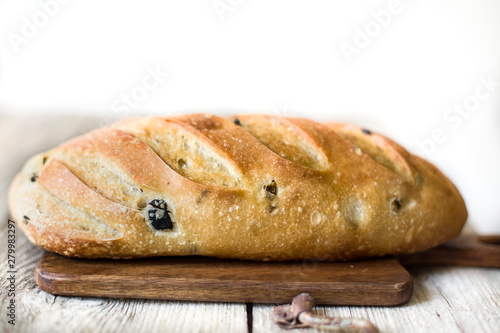 freshly baked sourdough bread loaf on the table on the white