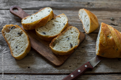 sliced sourdough bread loaf on the wooden table flat lay
