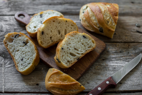 sliced sourdough bread loaf on the wooden table flat lay
