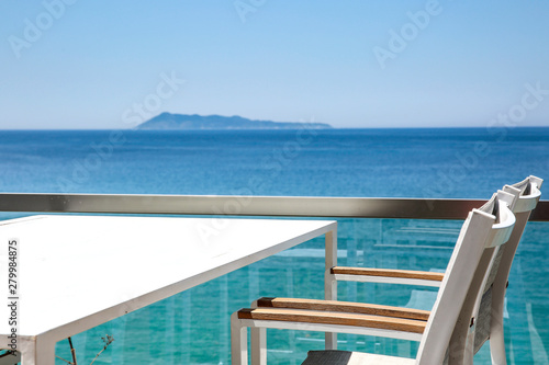 White table with chairs on the beautiful ocean view.