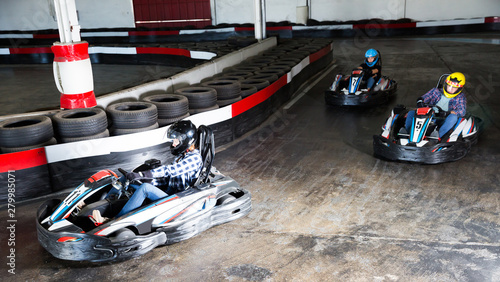 Man and women competing on racing cars