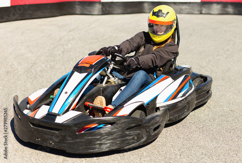 Woman driving sport car for karting in a circuit lap outdoor in sport club