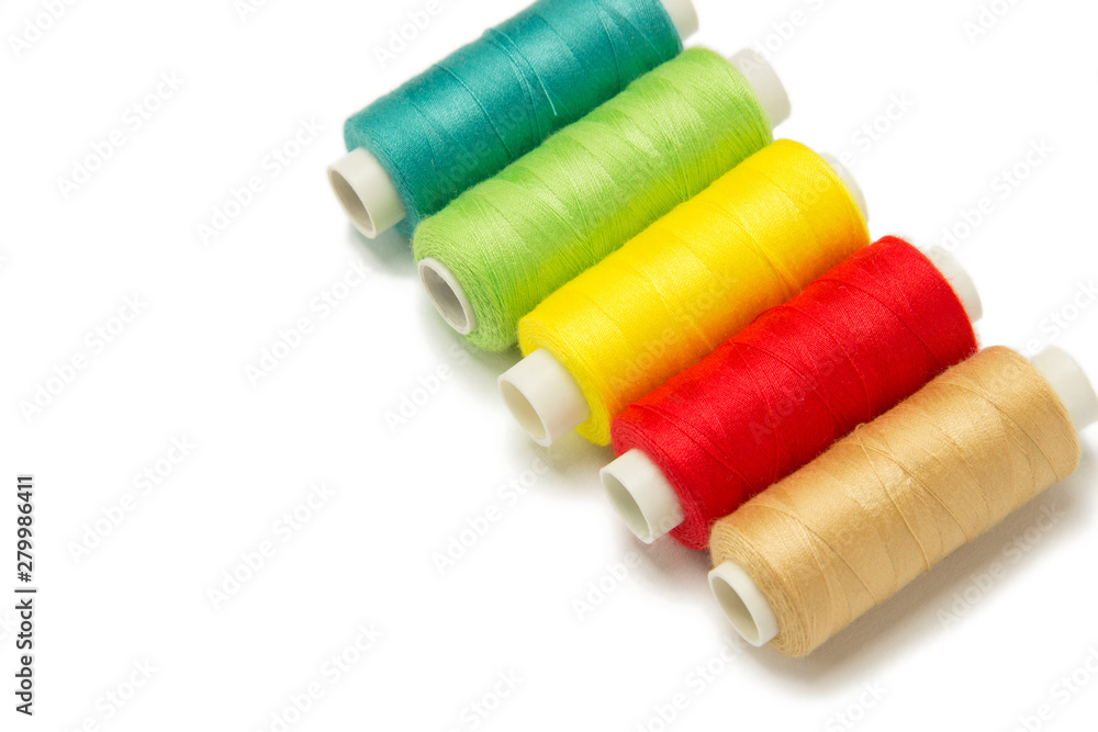 Closeup of red, yellow, golden and green threads isolated on white background. Hand made objects Closeup of red, yellow, golden and green threads isolated on white background. Hand made objects