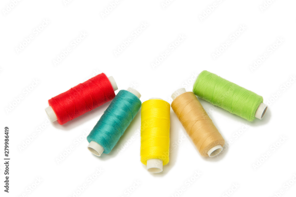 Closeup of red, yellow, golden and green threads isolated on white background. Hand made objects Closeup of red, yellow, golden and green threads isolated on white background. Hand made objects