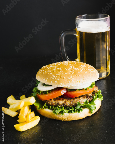 High angle close-up burger with fries and beer