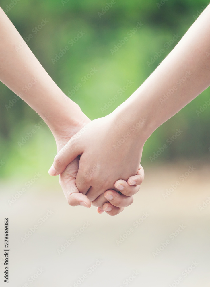 two asian woman holding hands two asian woman holding hands