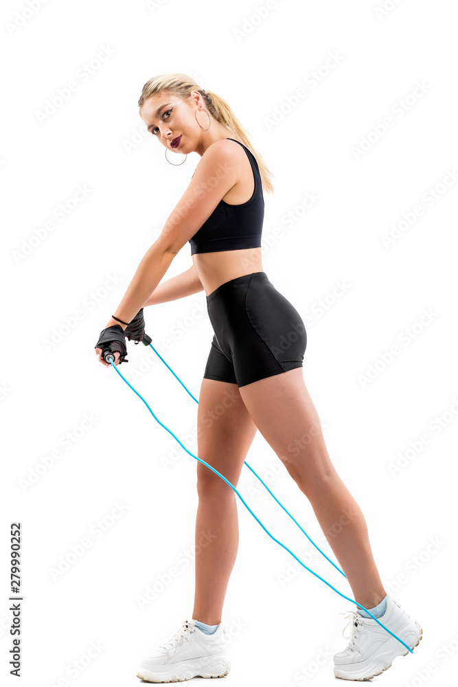 Beautiful sportsgirl with skipping rope isolated on white Beautiful sportsgirl with skipping rope isolated on white