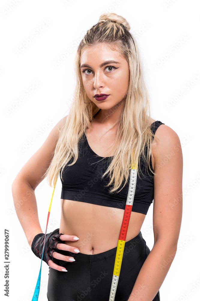 Fit woman measuring her waist - isolated over a white background Fit woman measuring her waist - isolated over a white background