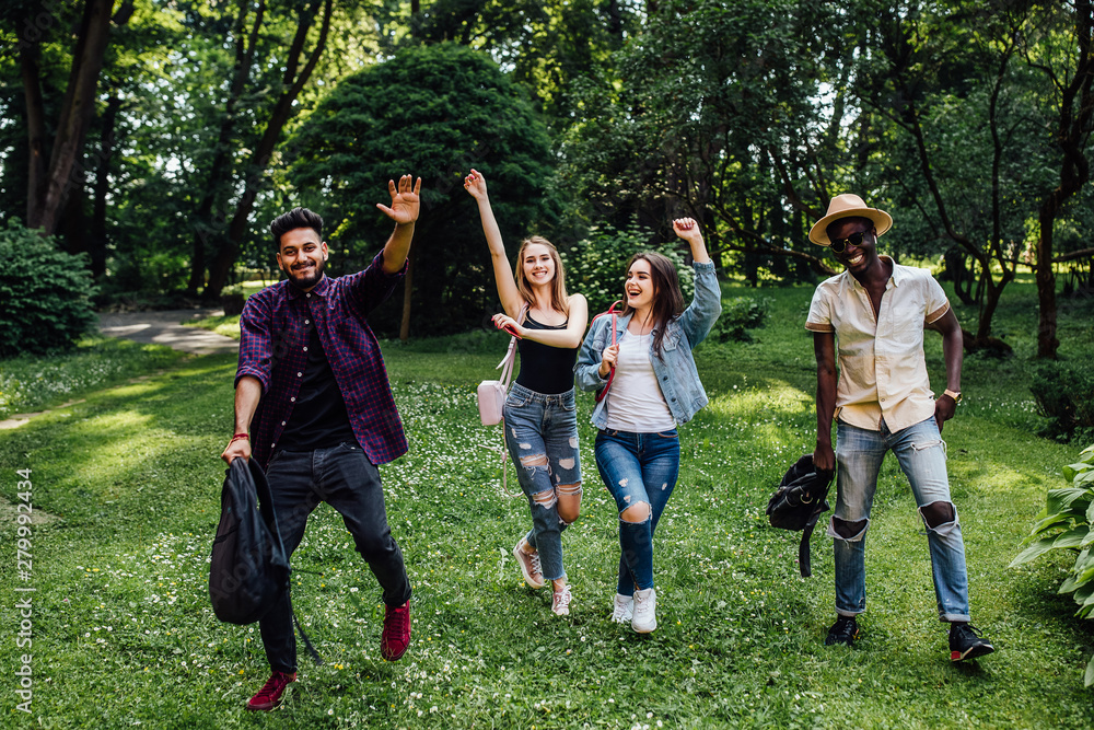 Fototapeta premium Hapiness. Smiling students happy to go home. Joyful girls and boys wearing backpack and running outside the campus at the lessons.