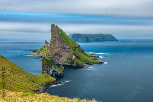 Amazing top view long exposure of Drangarnir gate in front of Tindholmur, Faroe Islands photo