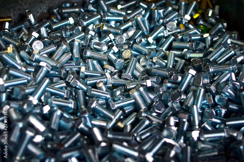 Background of screw bolts  Internal screw  nuts  many screws.  Factory equipment and Industrial concept. Small roughness sharpness  possible granularity  blurred focus  - Image