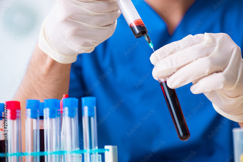 Young lab assistant testing blood samples in hospital Young lab assistant testing blood samples in hospital