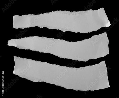 White paper scraps isolated on black background and texture