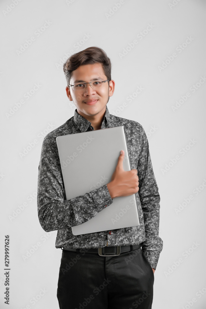 Young Indian / Asian man working on laptop Young Indian / Asian man working on laptop