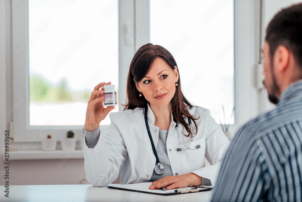 Female medicine doctor prescribing pills to a patient. Female medicine doctor prescribing pills to a patient.