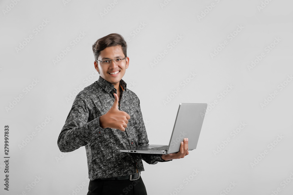 Young Indian / Asian man working on laptop Young Indian / Asian man working on laptop