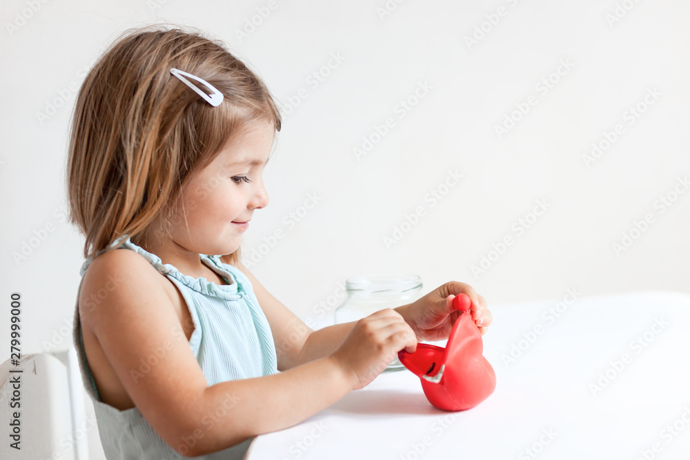 Toddler girl with red wallet,purse play with coins at home Toddler girl with red wallet,purse play with coins at home