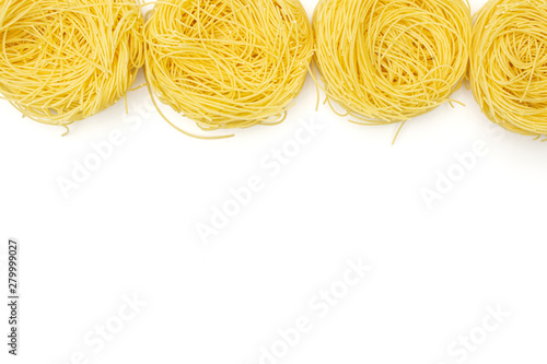 Group of four whole raw pasta angel hair copyspace below flatlay isolated on white background