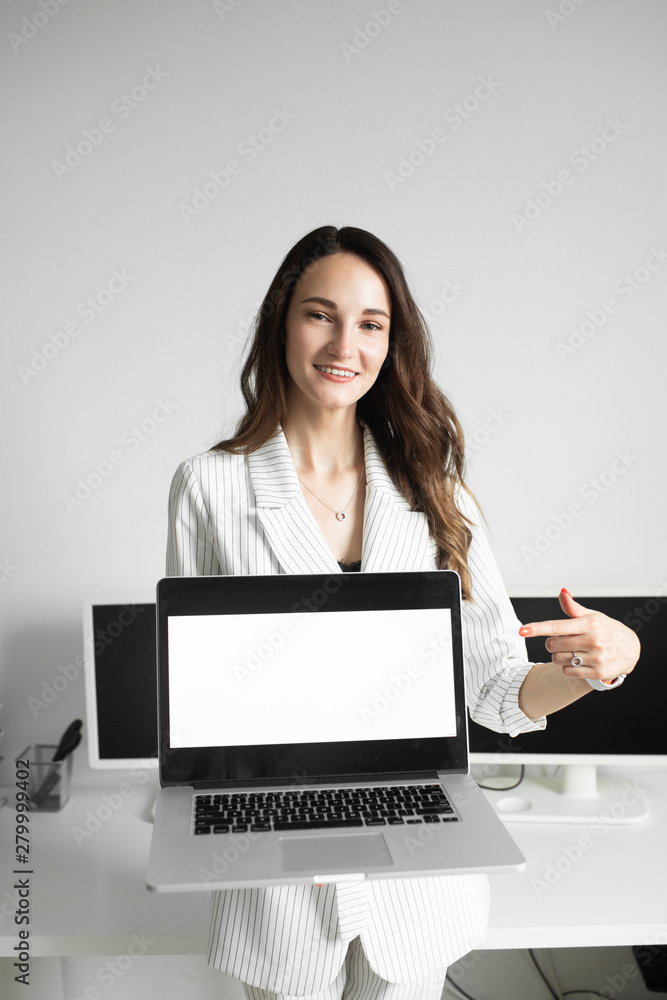 girl in the office holding a laptop girl in the office holding a laptop