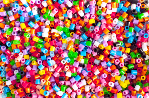 Obraz na plátně Bright colorful plastic perler beads. Abstract background
