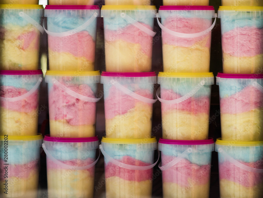 colorful cotton candy in buckets during fair market