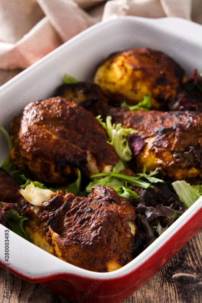 Roasted tandoori chicken with basmati rice on wooden table Roasted tandoori chicken with basmati rice on wooden table
