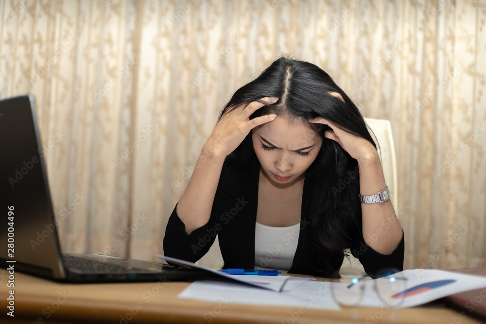 A business women are stressed in the work. When the malfunction by removing the hands clasping head.. A business women are stressed in the work. When the malfunction by removing the hands clasping head..