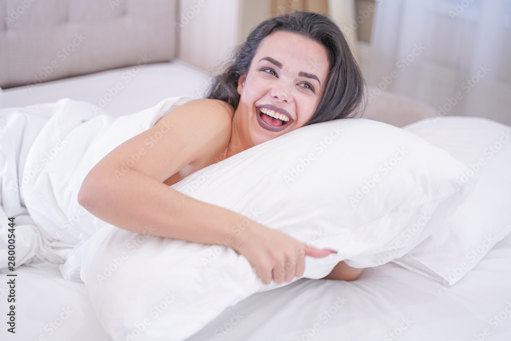 charming young brunette girl resting in her white bed charming young brunette girl resting in her white bed